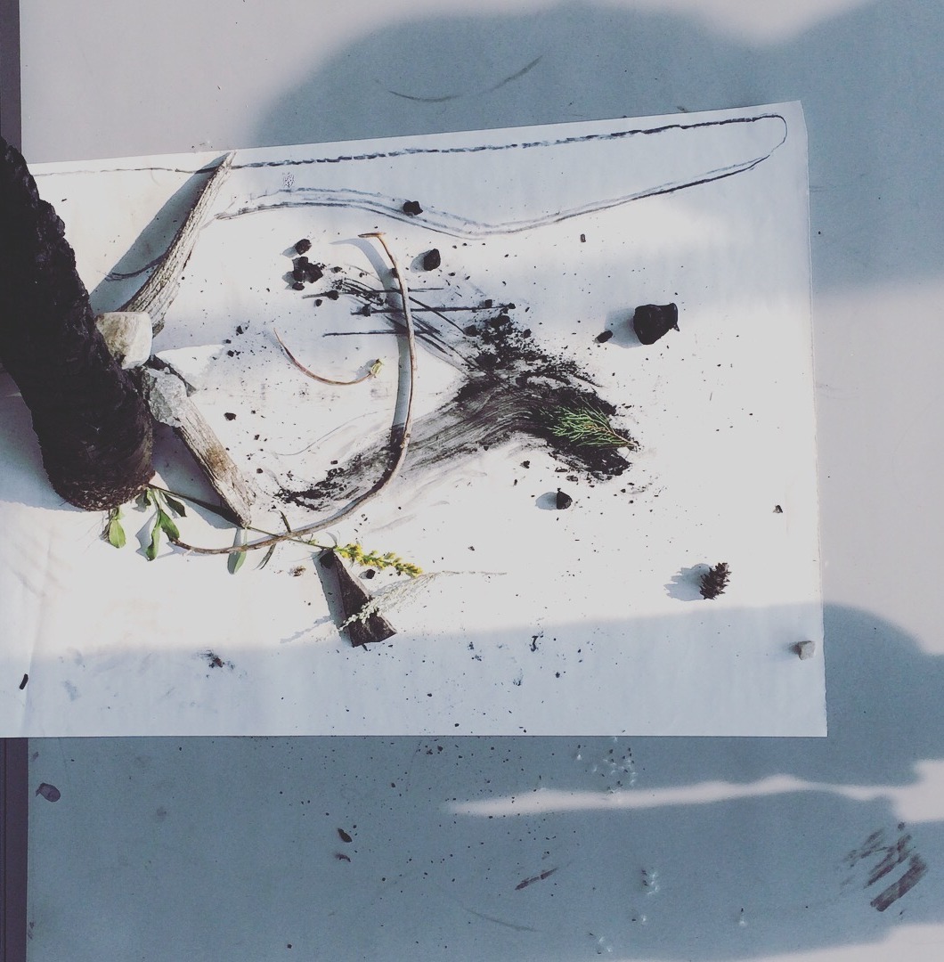 Open notebook, dried flowers and a terracotta cup on warm linen